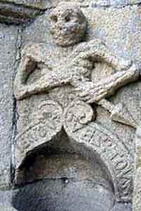 Ankou (death) image sculpted above a holy water font (Brittany).