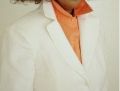 Close up of 2 collars up, shirt & blazer, with shirt closed