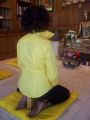 Yellow shirt with collar up, kneeling position