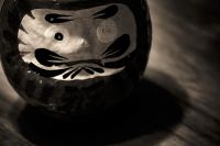 A daruma doll with one eye filled in for wishing.