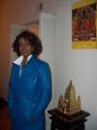 Buddhist with collar up, next to a Maha Bodhi Temple replica