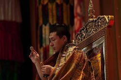 The 17th Gyalwa Karmapa, Trinlay Thaye Dorje using the Bell and Dorje during an empowerment.